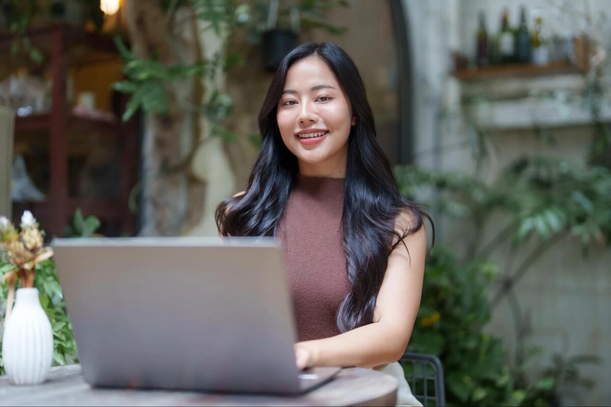 Managing Your Website Post-Launch Business owner working on a laptop outdoors while managing her website